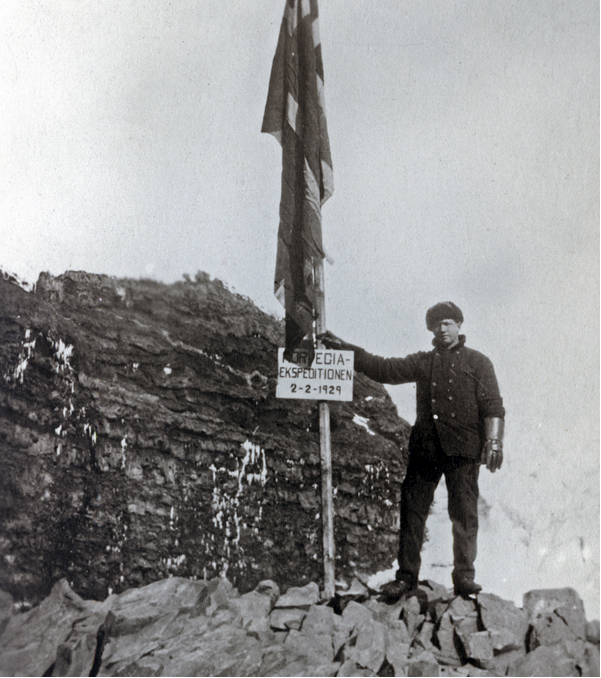 Norwegian expedition member raising the Norwegian flag on Peter I Island on 2 February 1929